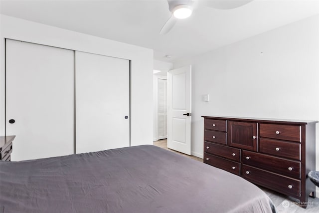 unfurnished bedroom with a closet, hardwood / wood-style floors, and ceiling fan