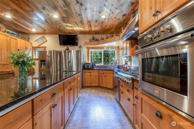 kitchen featuring light tile flooring, wooden ceiling, stainless steel appliances, dark stone counters, and range hood