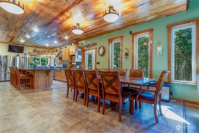 dining area featuring wooden ceiling and light tile floors