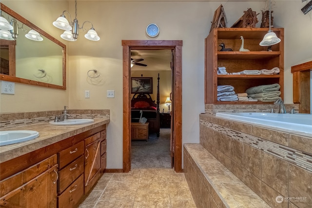 bathroom with tile flooring, ceiling fan, tiled bath, and double sink vanity