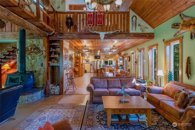 interior space with wood ceiling, a wood stove, high vaulted ceiling, and built in features