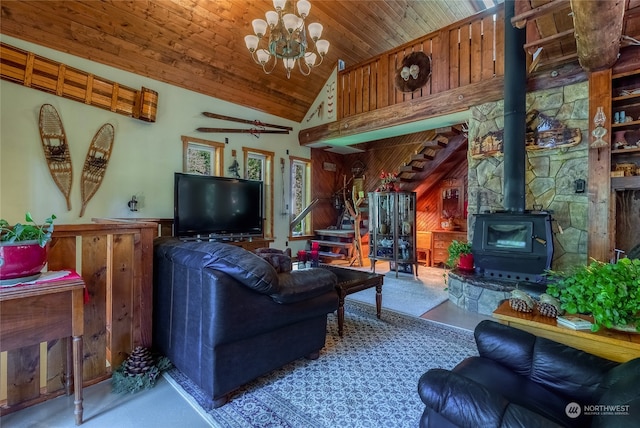 living room with a wood stove, wood walls, high vaulted ceiling, a chandelier, and wood ceiling