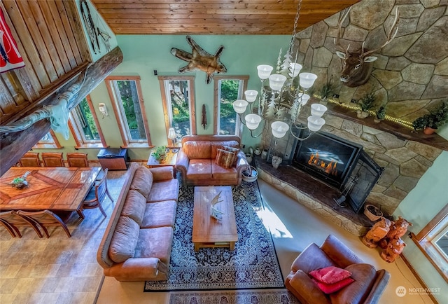 living room featuring high vaulted ceiling, wooden ceiling, and a stone fireplace