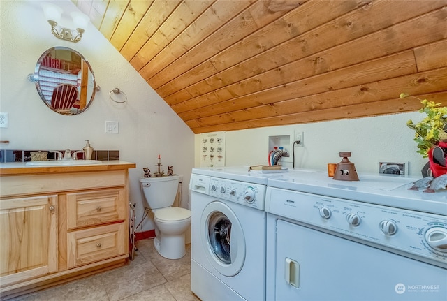 washroom with sink, light tile flooring, hookup for a washing machine, wooden ceiling, and separate washer and dryer