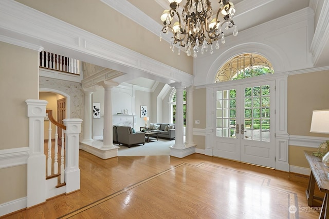 foyer entrance with ornate columns and crown molding