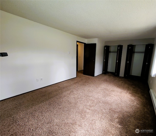 6114 Glen Mary Ln SE Unit A-D, Lacey, WA 98503 - unfurnished bedroom featuring multiple closets, a textured ceiling, and carpet flooring