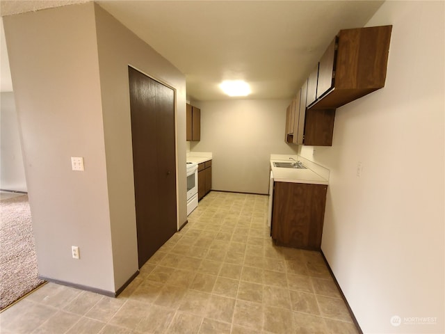 6114 Glen Mary Ln SE Unit A-D, Lacey, WA 98503 - kitchen with light colored carpet, dark brown cabinets, sink, and white electric range