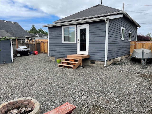 rear view of house featuring a fire pit