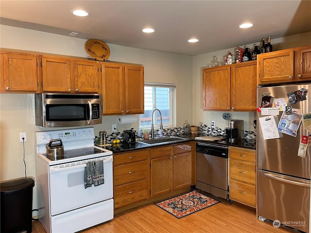 kitchen featuring sink, light hardwood / wood-style floors, and appliances with stainless steel finishes