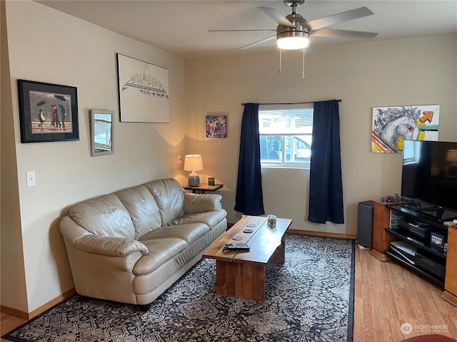 living room featuring ceiling fan and light hardwood / wood-style flooring