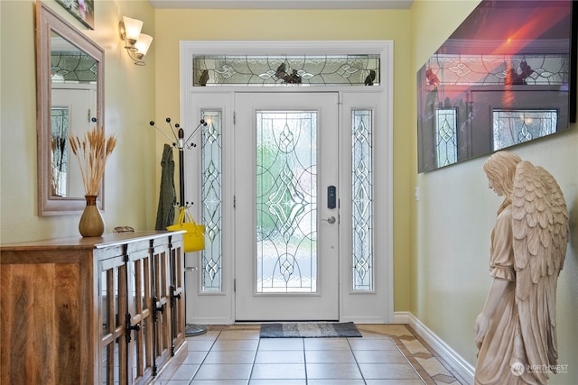 tiled entrance foyer with a healthy amount of sunlight