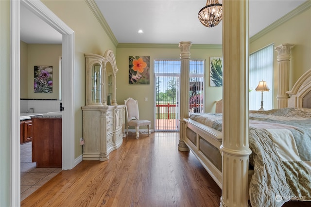 bedroom featuring access to outside, an inviting chandelier, light hardwood / wood-style floors, crown molding, and ensuite bath