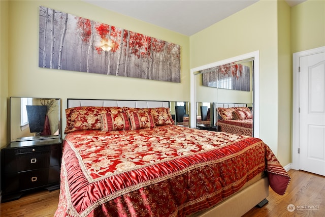 bedroom with light hardwood / wood-style flooring and multiple windows