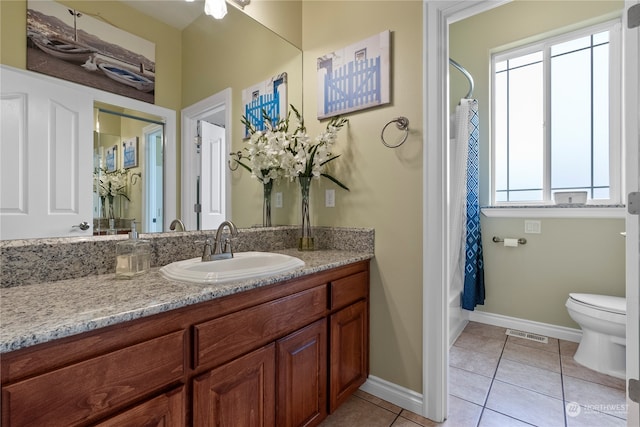 full bathroom featuring vanity, shower / bath combination with curtain, toilet, and tile patterned floors