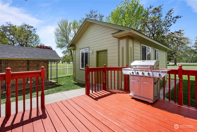 wooden terrace featuring a lawn