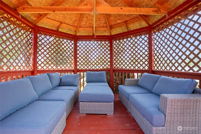 wooden deck featuring a gazebo and an outdoor hangout area