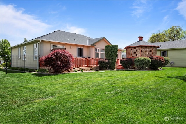 back of property with a gazebo, a yard, and a wooden deck