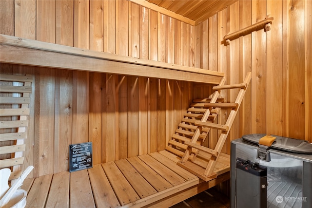 view of sauna with wood walls