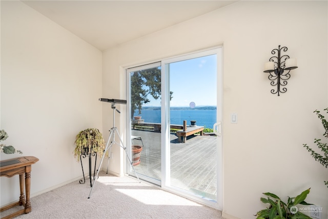 doorway featuring carpet flooring and a water view