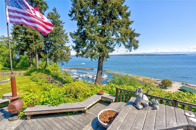 wooden terrace featuring a water view