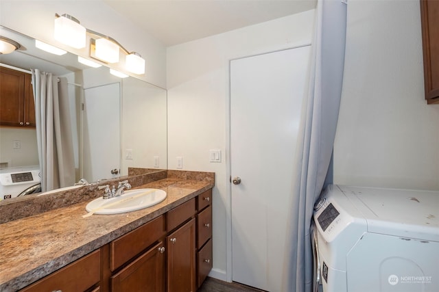 bathroom with vanity and independent washer and dryer