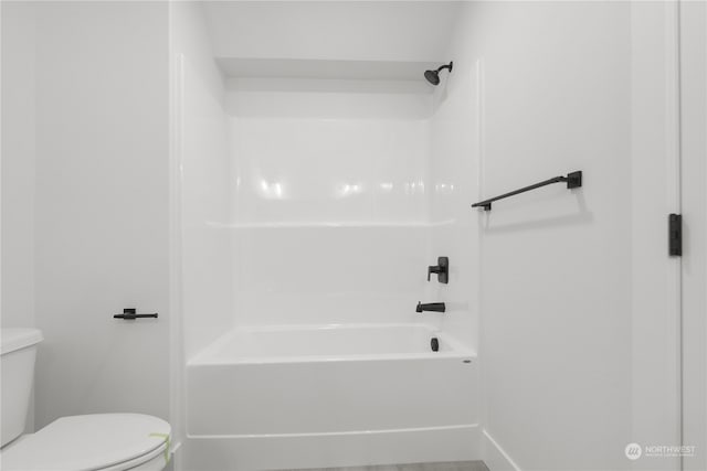 bathroom featuring shower / washtub combination and toilet