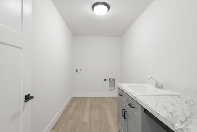 laundry room featuring light hardwood / wood-style floors, washer hookup, hookup for an electric dryer, sink, and cabinets