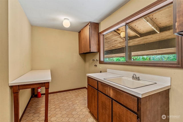 kitchen with sink, light tile flooring, and wood ceiling