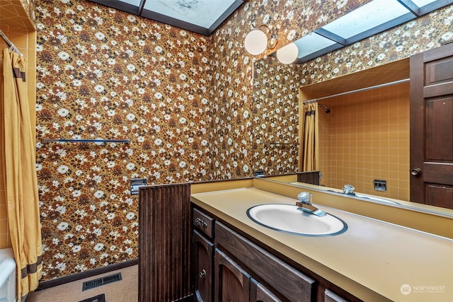 bathroom featuring vanity and shower / bath combo with shower curtain