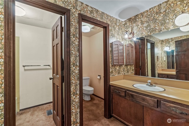 bathroom featuring oversized vanity and toilet