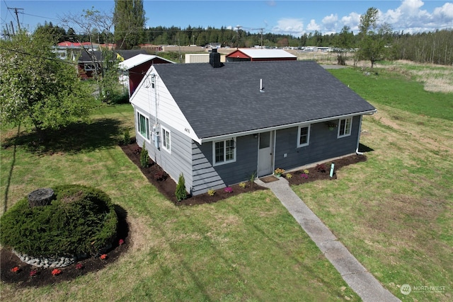 rear view of house with a yard