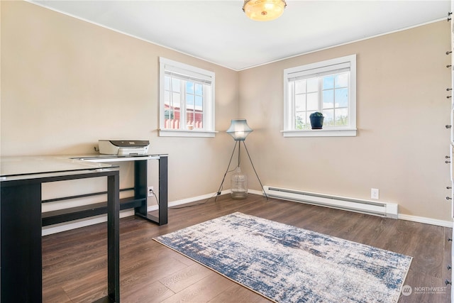 office space with a baseboard radiator, dark wood-type flooring, and plenty of natural light