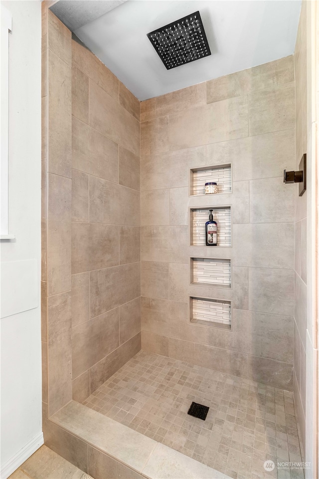 bathroom with tiled shower