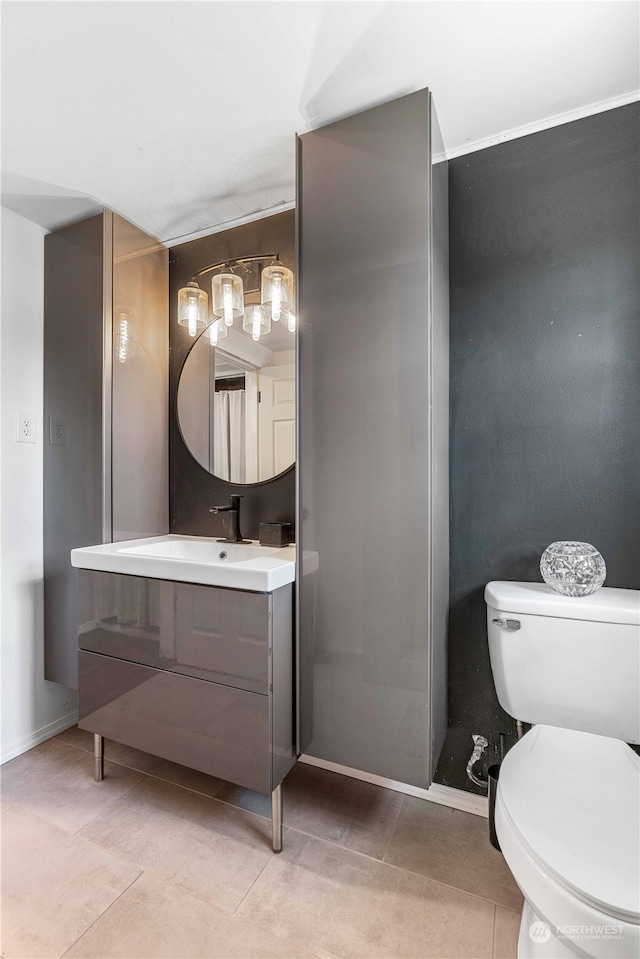 bathroom with vanity, toilet, and tile floors