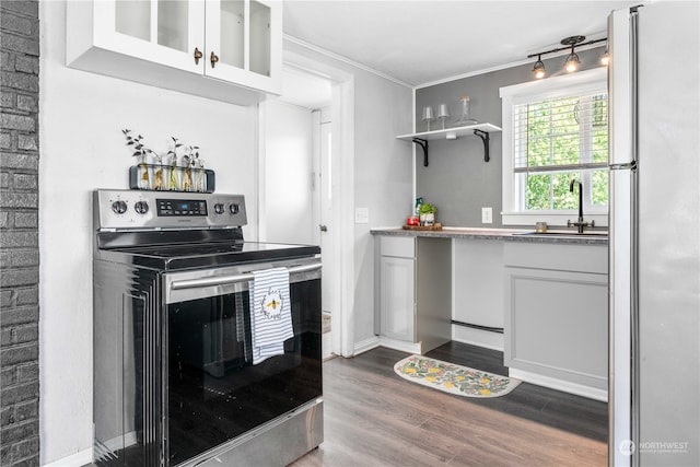 kitchen with refrigerator, stainless steel electric range oven, white cabinets, sink, and dark hardwood / wood-style flooring