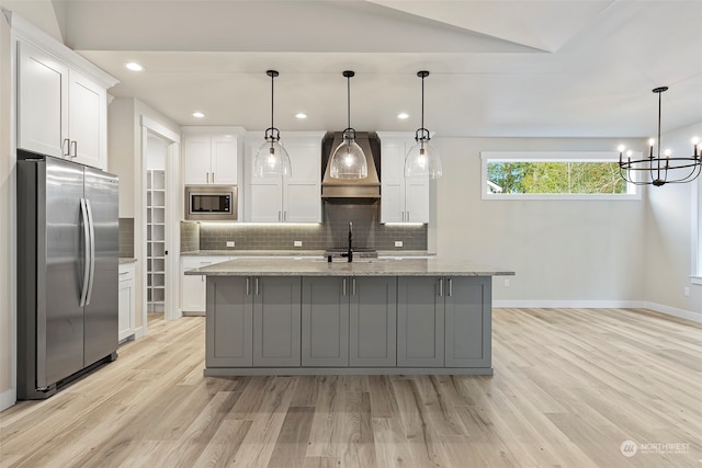 kitchen with white cabinetry, pendant lighting, and stainless steel appliances