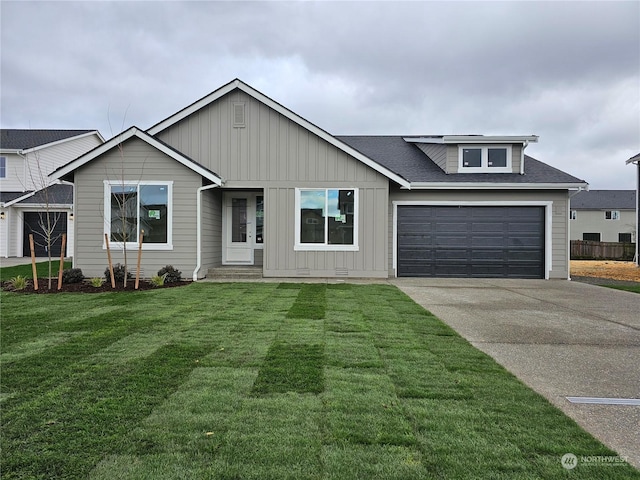 view of front of property with a front yard and a garage