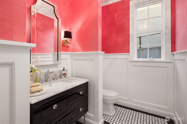 bathroom with tile floors, toilet, and vanity