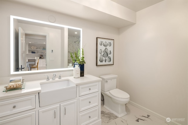 bathroom featuring tile floors, vanity, and toilet