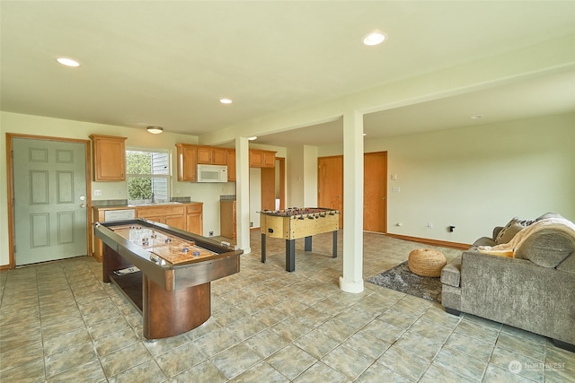 rec room with sink and light tile flooring