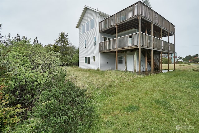 rear view of property with a yard and a wooden deck