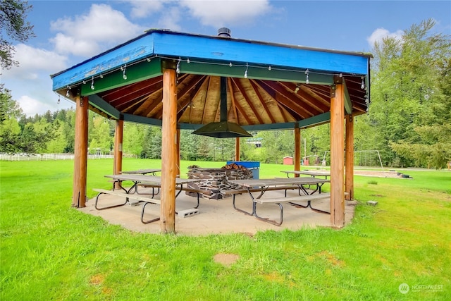 view of community featuring a gazebo, a patio, and a lawn