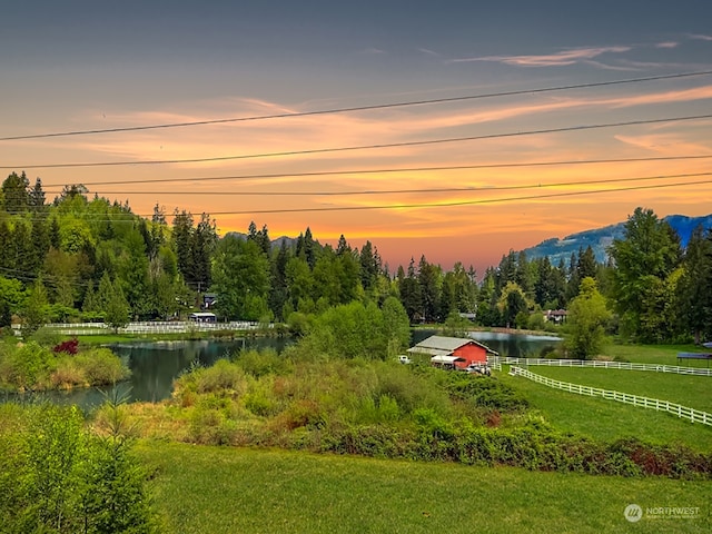 surrounding community featuring a yard and a water view