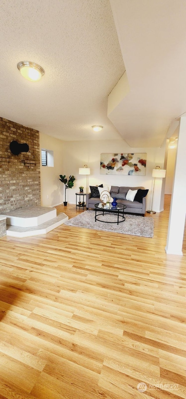 unfurnished living room featuring wood-type flooring and a textured ceiling