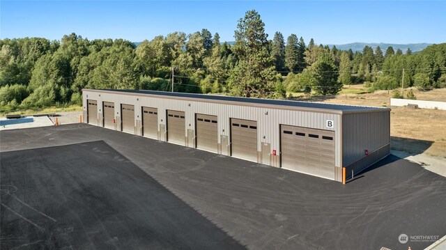 garage featuring a view of trees