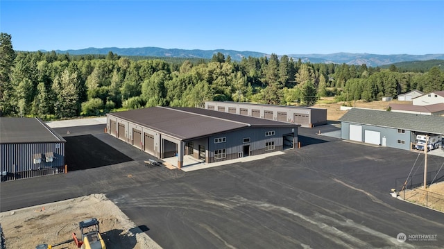 drone / aerial view with a forest view and a mountain view