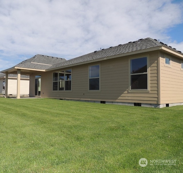 back of house with a lawn