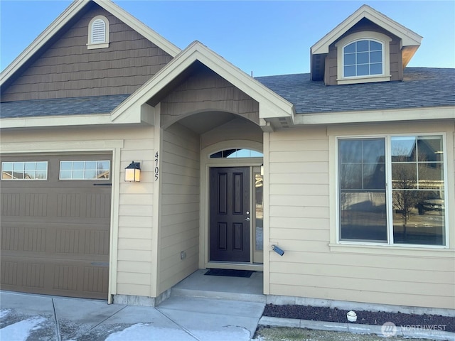 view of exterior entry with a garage