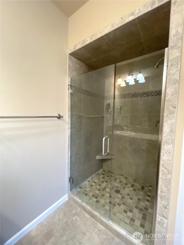 bathroom featuring tile patterned floors and a shower with door