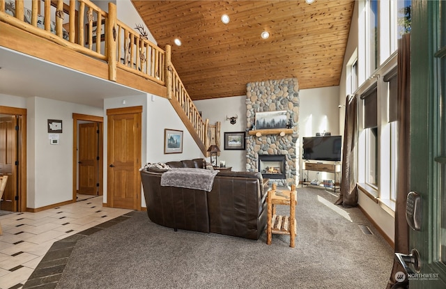 tiled living room with high vaulted ceiling, a fireplace, and wood ceiling